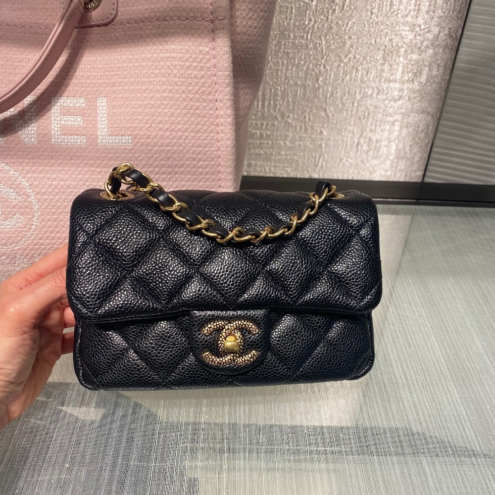 Chanel Mini Flap in black caviar leather with gold hardware
